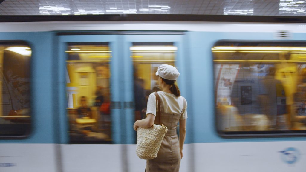 Young woman waiting for a train at the station in Paris